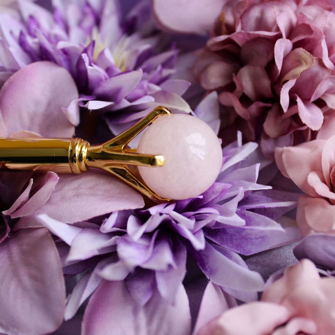 Rose Quartz pen lying on a bed of pink flowers