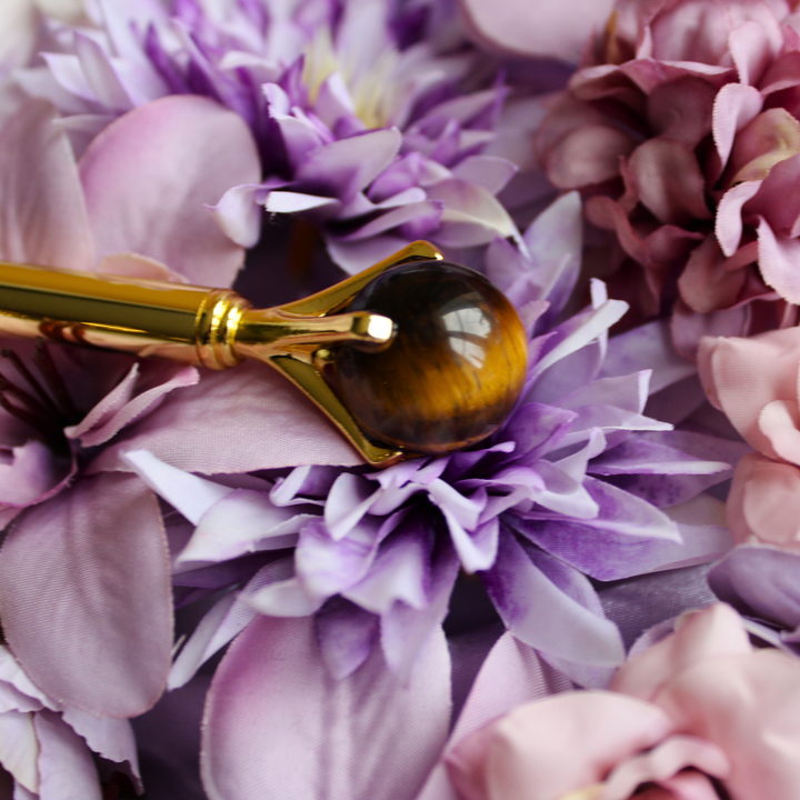 Tigers Eye pen lying on a bed of flowers