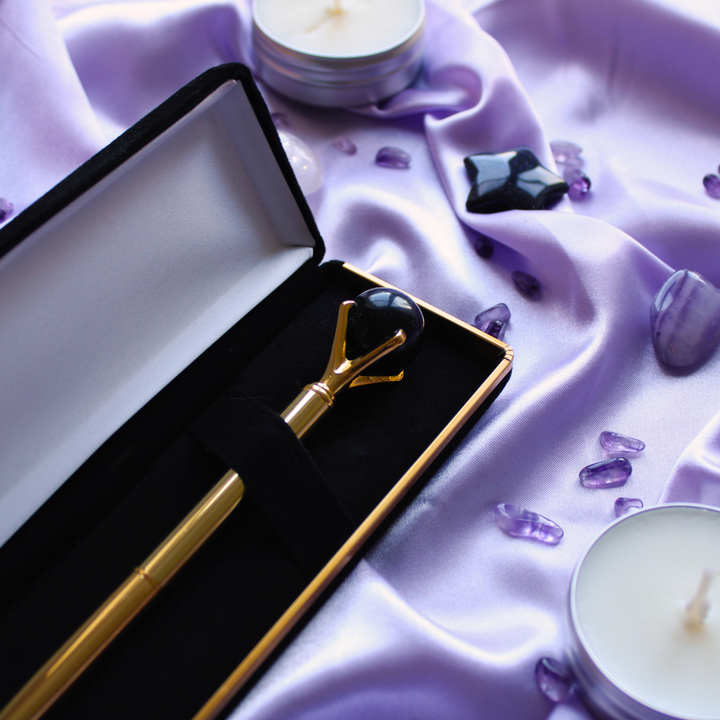 Gold crystal pen surrounded by protection crystals