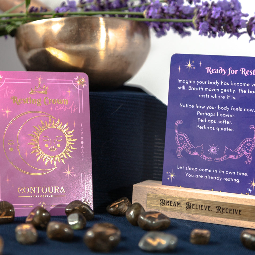 Two Resting Crown Sleep cards on a dark surface with crystals and a bowl of flowers in the background.